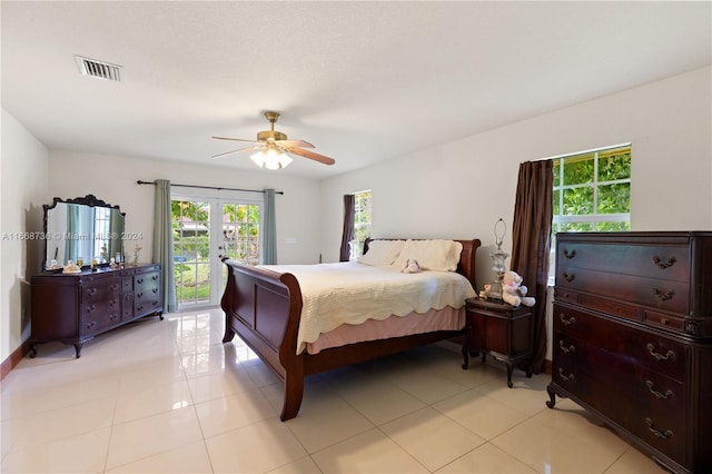 tiled bedroom with ceiling fan, access to exterior, and french doors