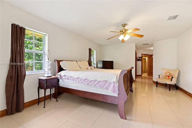 bedroom with ceiling fan and light tile patterned flooring