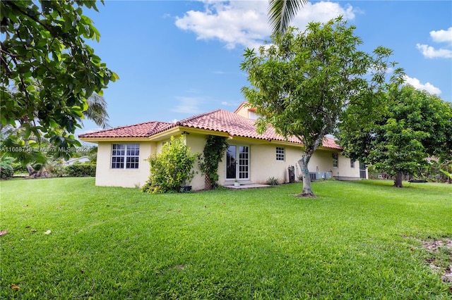 back of house with a lawn