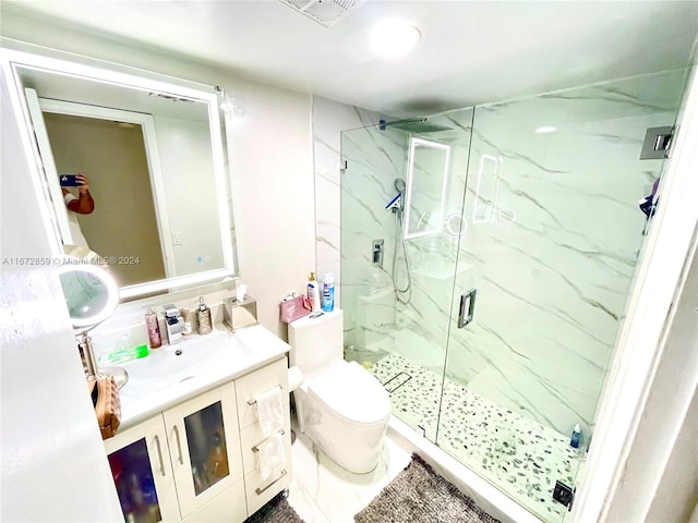 bathroom featuring walk in shower, vanity, and toilet