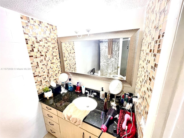 bathroom with decorative backsplash and vanity