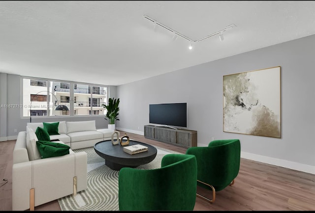 living room featuring rail lighting and hardwood / wood-style floors