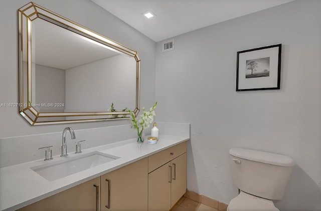 bathroom with vanity, tile patterned flooring, and toilet