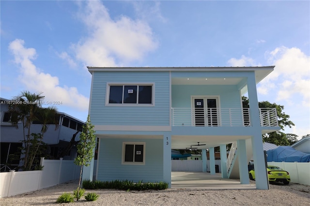 view of front of home with a balcony and ceiling fan