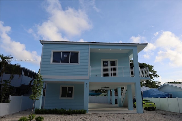 view of front of property featuring a balcony and ceiling fan