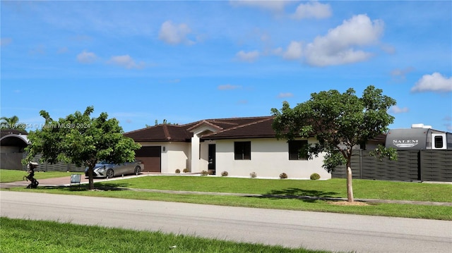 view of front facade featuring a front yard and a garage