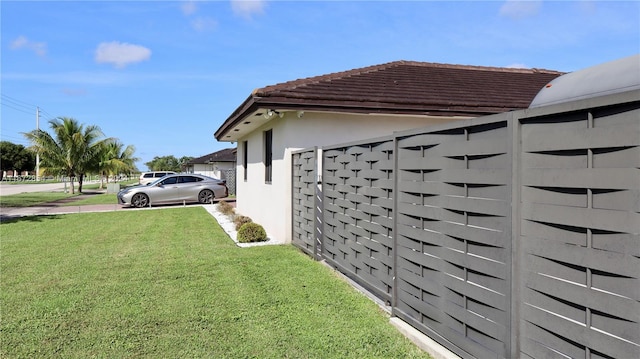 view of side of home with a lawn