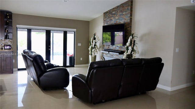 living room featuring french doors, light tile patterned floors, and lofted ceiling