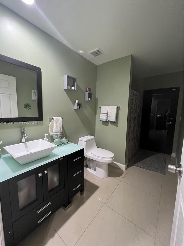 bathroom featuring vanity, toilet, a shower with curtain, and tile patterned flooring