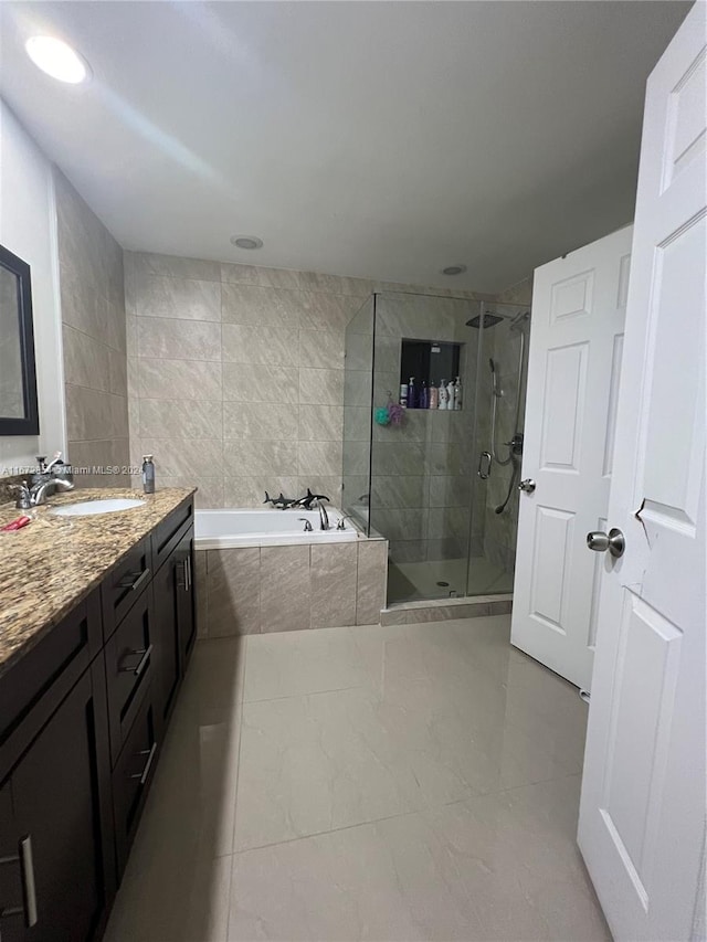 bathroom with vanity, shower with separate bathtub, and tile patterned flooring