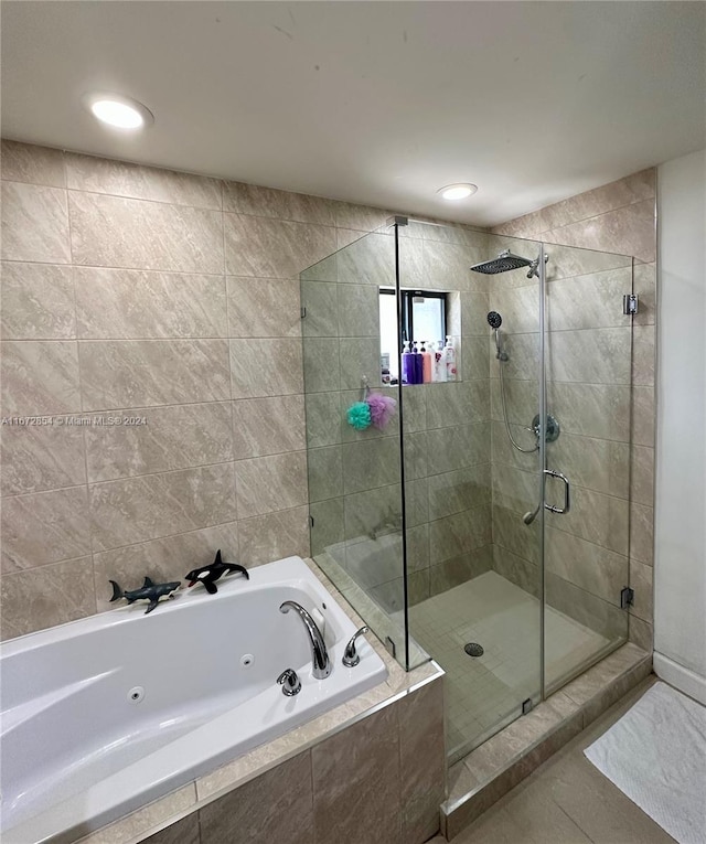 bathroom with independent shower and bath and tile patterned flooring