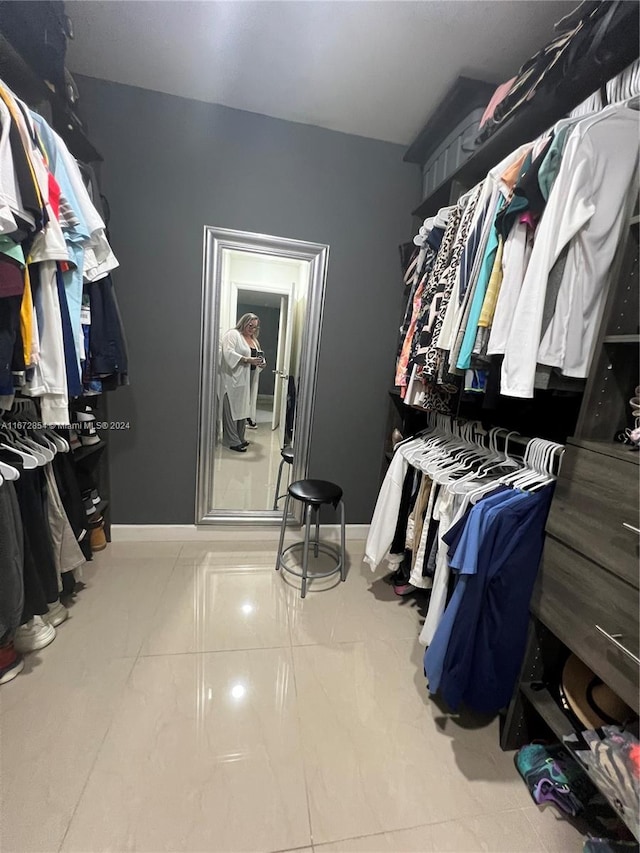 walk in closet with tile patterned floors