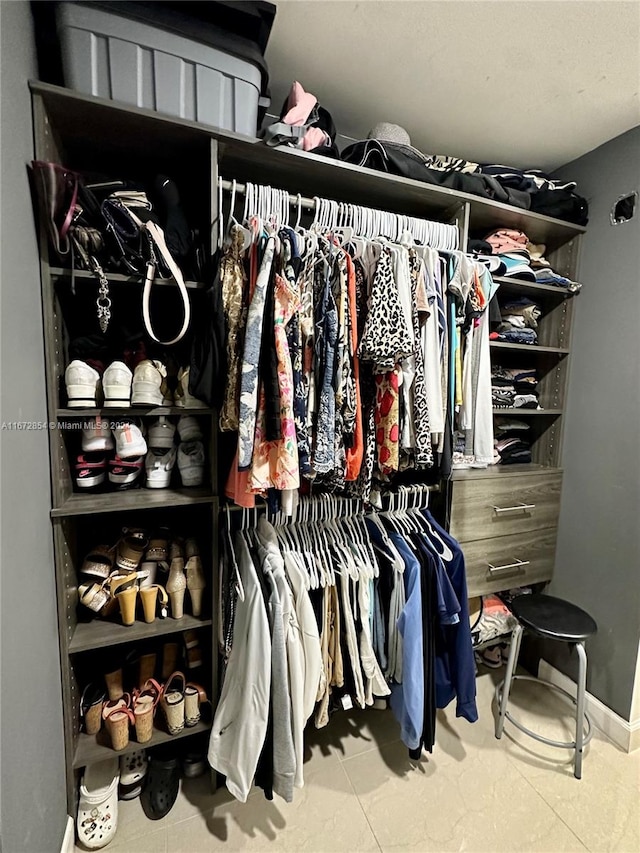 spacious closet with tile patterned floors