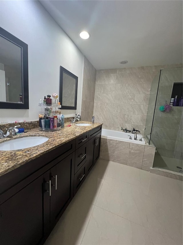 bathroom with vanity and independent shower and bath