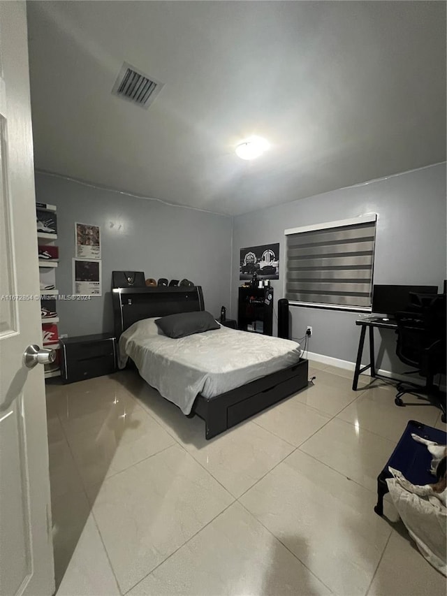 bedroom with light tile patterned floors