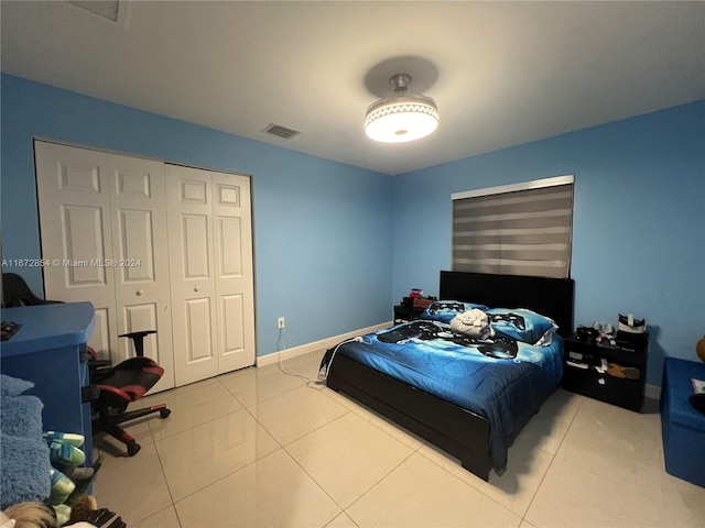 tiled bedroom with a closet