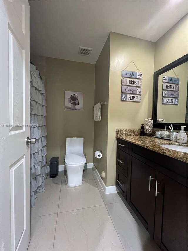 bathroom featuring vanity, a shower with shower curtain, and toilet