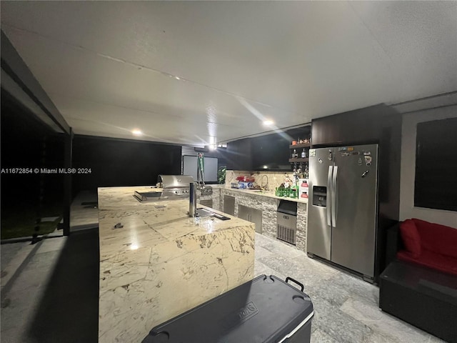 kitchen featuring sink and stainless steel fridge with ice dispenser