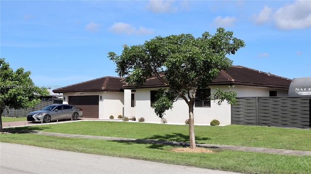 ranch-style home with a front lawn and a garage