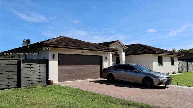 view of side of property featuring a lawn and a garage