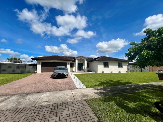 single story home with a front yard and a garage