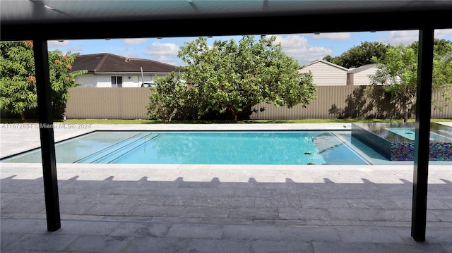 view of swimming pool featuring a patio