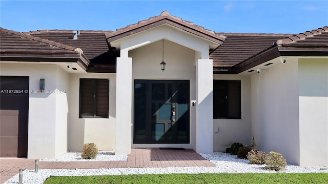 20461 SW 320th St, Homestead, FL 33030 - property entrance featuring a tile roof, stucco siding, and a garage