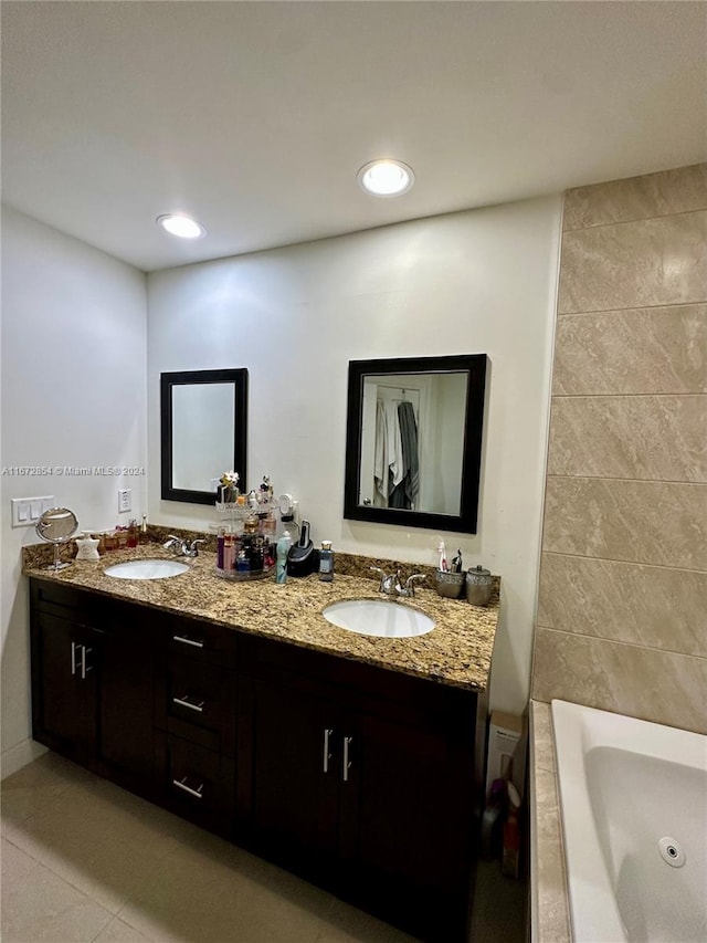 bathroom featuring vanity, tile patterned flooring, and a washtub