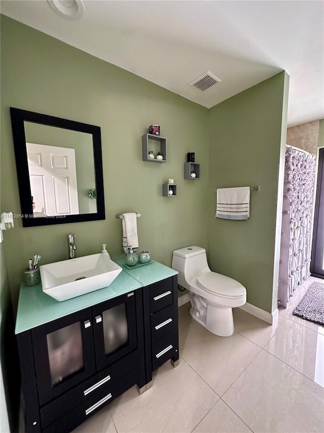 bathroom featuring vanity, toilet, tile patterned flooring, and a shower with shower curtain