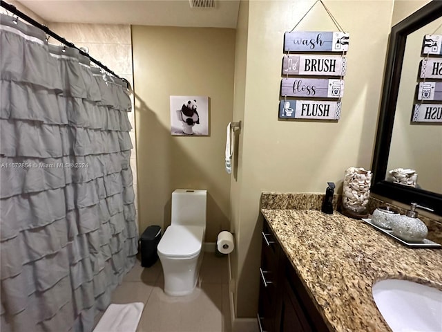 bathroom with vanity, a shower with curtain, toilet, and tile patterned floors