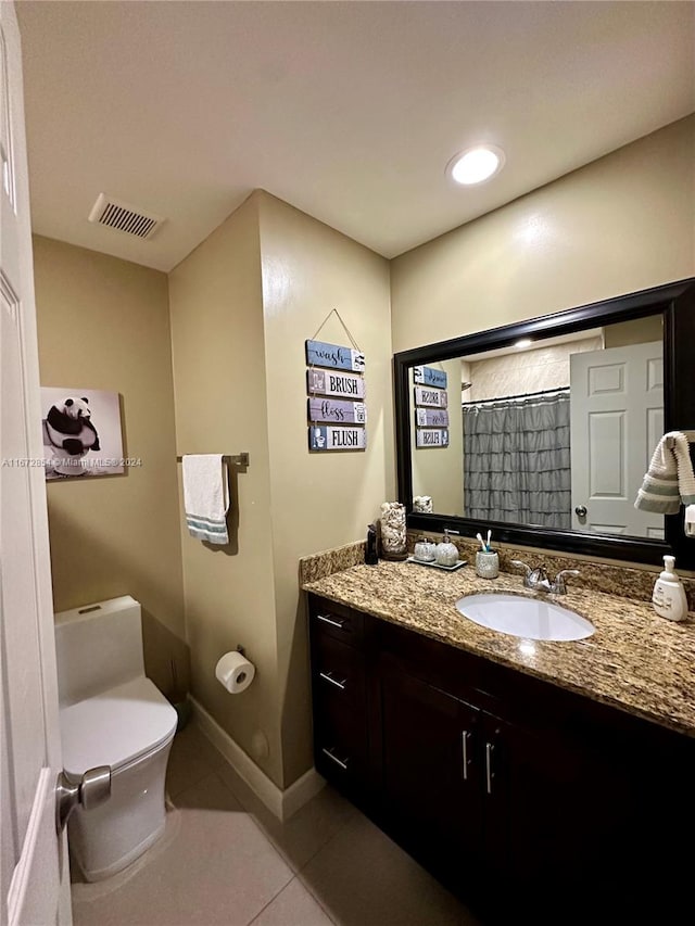 bathroom with vanity, toilet, and tile patterned floors