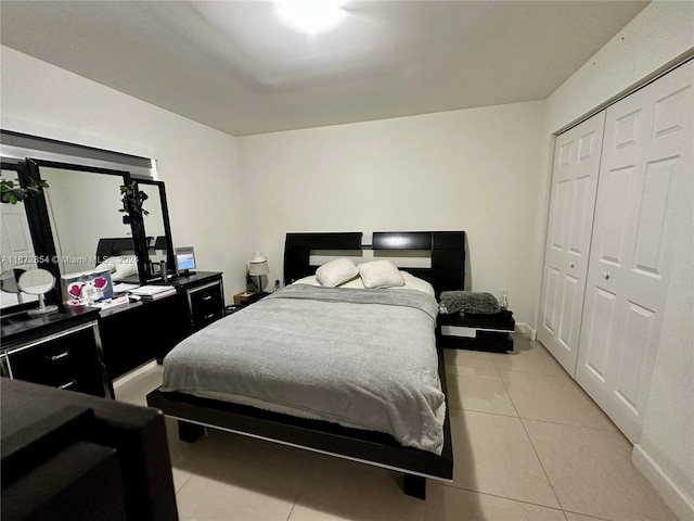 tiled bedroom with a closet