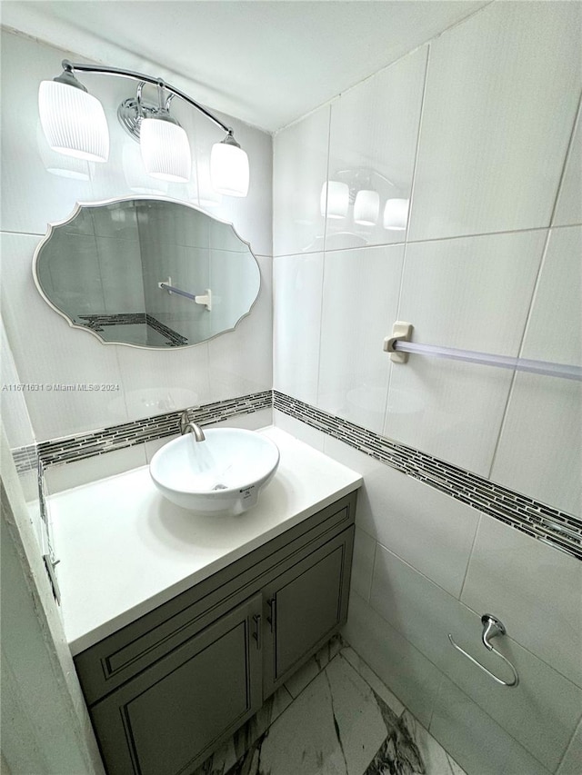 bathroom featuring tile walls and vanity