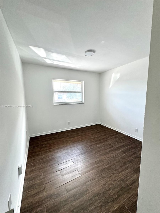 unfurnished room featuring dark hardwood / wood-style flooring