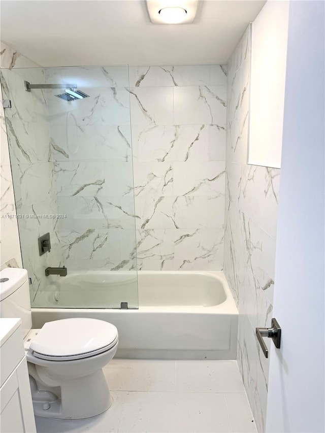 full bathroom featuring tiled shower / bath, vanity, and toilet