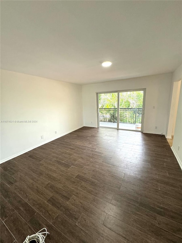 spare room with dark wood-type flooring