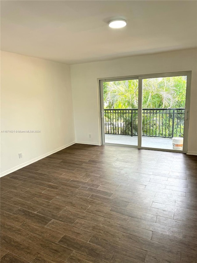 spare room with dark hardwood / wood-style flooring