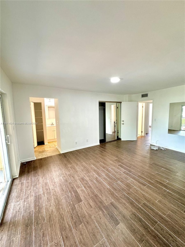 unfurnished living room featuring wood-type flooring