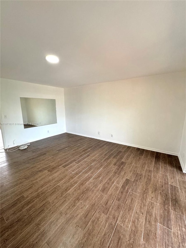 empty room with dark wood-type flooring