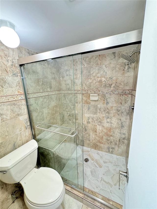 bathroom with an enclosed shower and toilet