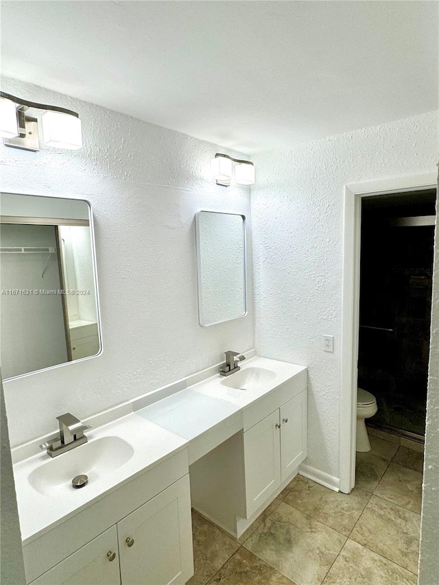 bathroom featuring tile patterned flooring, vanity, and toilet