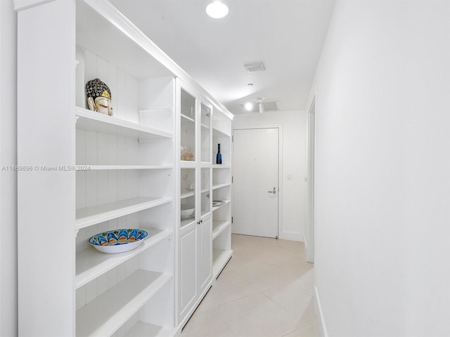 walk in closet featuring light tile patterned flooring