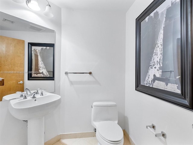 bathroom with tile patterned flooring and toilet