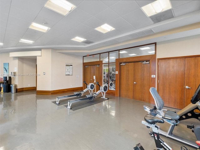 workout area with a paneled ceiling