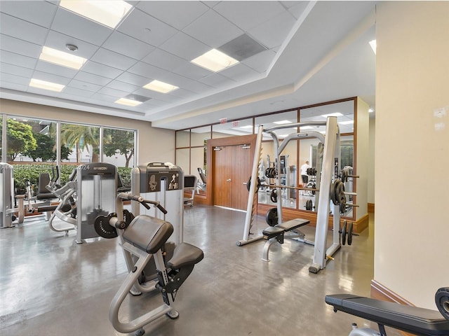 workout area with a drop ceiling and concrete floors