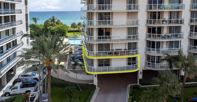 view of property with a water view and a community pool