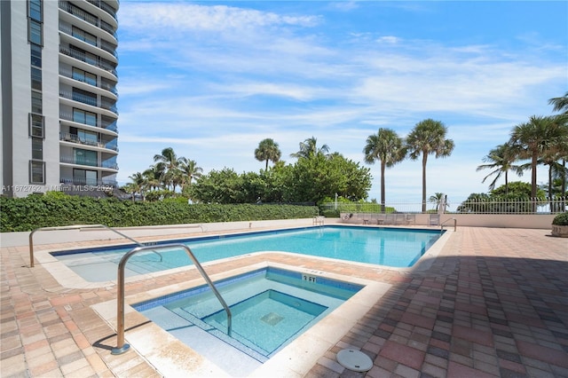 8855 Collins Ave Unit 2D, Surfside, FL 33154 - community pool featuring a hot tub and a patio