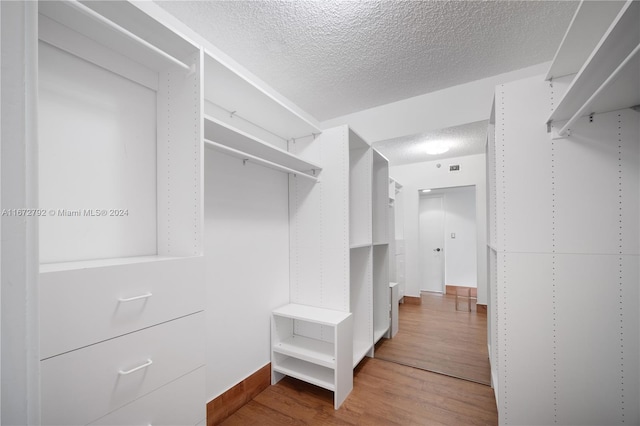 8855 Collins Ave Unit 2D, Surfside, FL 33154 - walk in closet with wood finished floors