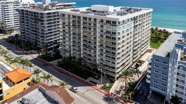 view of property featuring a beach view and a water view