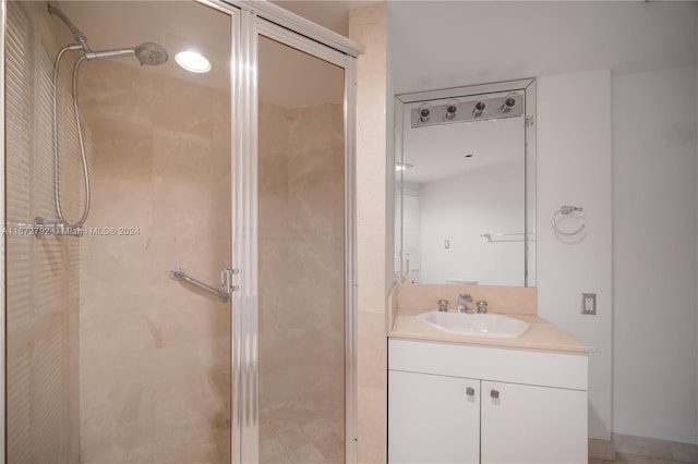 bathroom featuring vanity and a shower with door